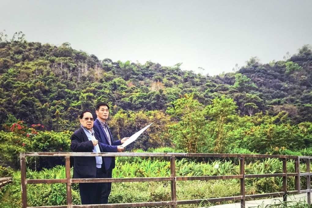 Wheelock Properties chairman Stewart Leung, left, and managing director Ricky Wong overlooking a site in Tai Po, one of three plots it will loan to NGOs for the use of temporary housing. Photo: SCMP Pictures