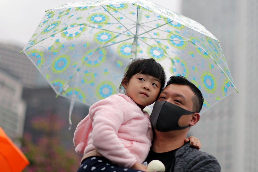 A demonstrator with a child attends an anti-government rally at Edinburgh Place on December 29. Photo: Reuters