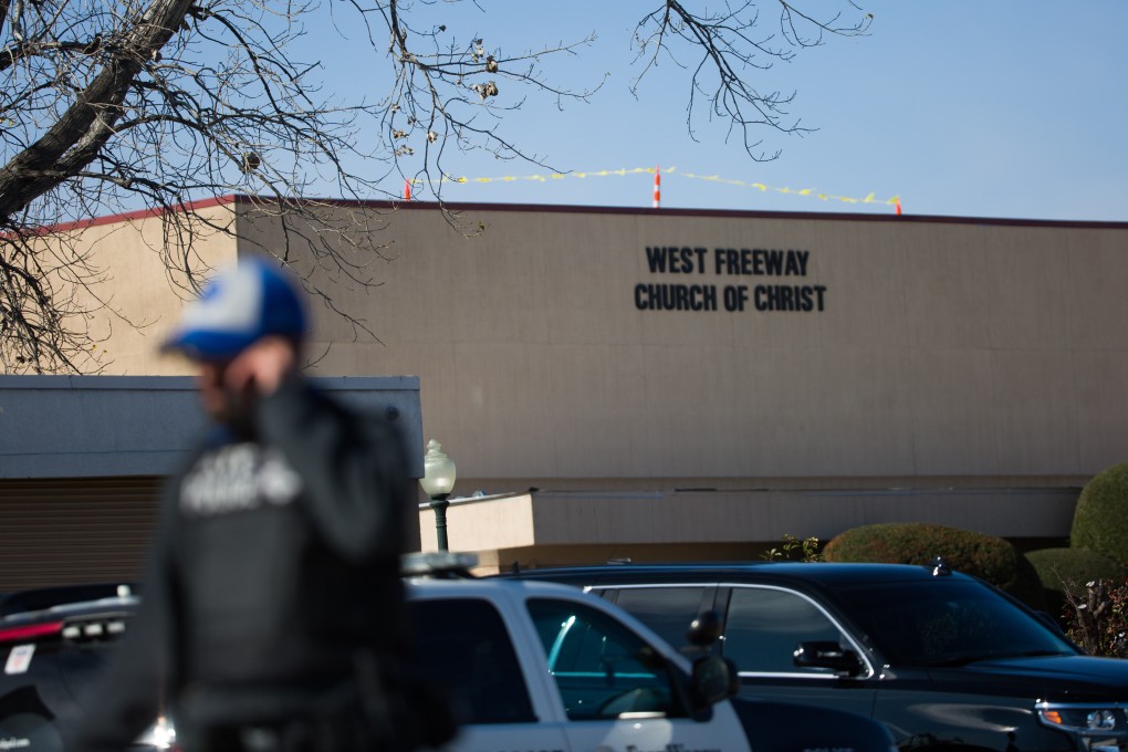 An officer walks near the scene after a church shooting at West Freeway Church of Christ on Sunday. Photo: The Dallas Morning News via AP
