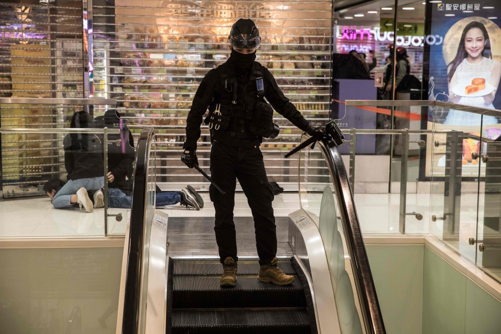 A pro-democracy protester (left) is detained during a rally at a shopping mall in Sheung Shui on December 28. Hong Kong’s tourism and retail sectors have been hit hard by the protests. Photo: AFP