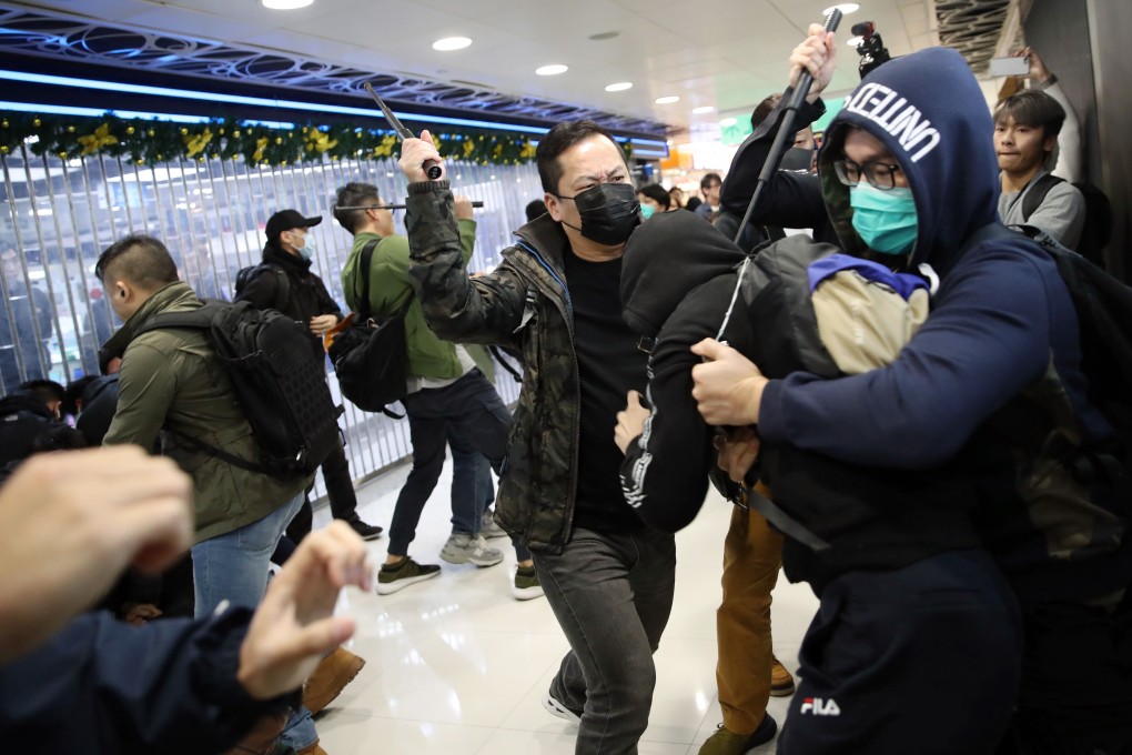 Plain-clothes police officers grapple with a protester in the Landmark North shopping centre. Photo: Winson Wong