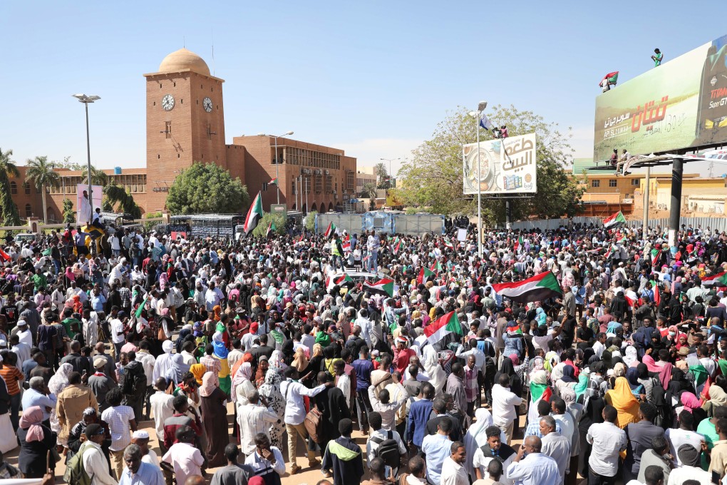 Sudanese people react as they gather in front of a court in Omdurman, near the capital Khartoum, on Monday. Photo: EPA