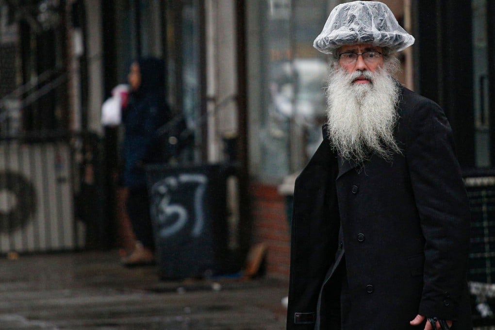 Police, state troopers and civilian volunteers stood guard at a Hasidic synagogue in Brooklyn on Monday as Orthodox Jews marked the end of Hanukkah under heightened security. Photo: AFP