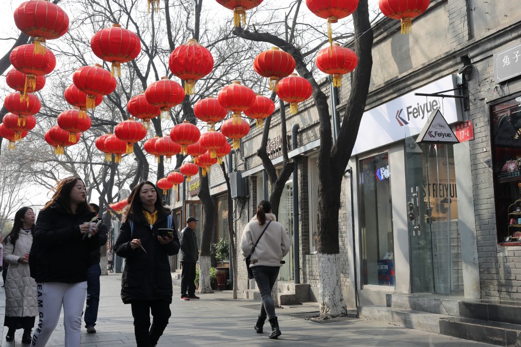 Tourists walk at Nanluoguxiang in Beijing. Nanluoguxiang has been developed into Beijing's busiest commercialised hutong. Photo: