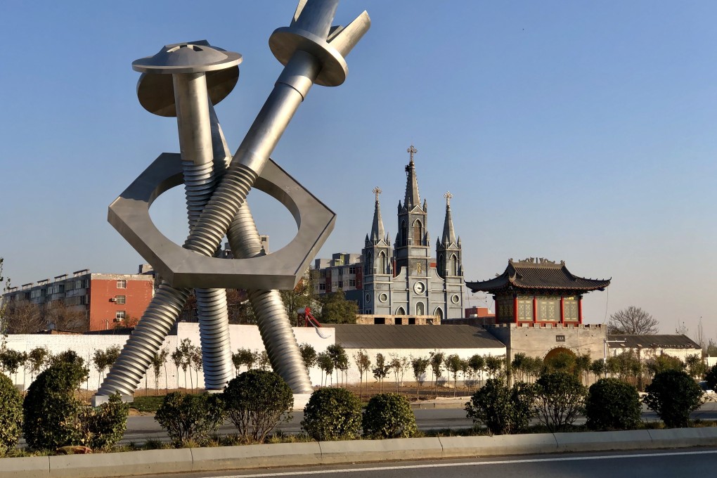 A statue of fasteners stands next to a motorway that passes through Hebei’s Yongnian district in China on December 4. Photo: Orange Wang