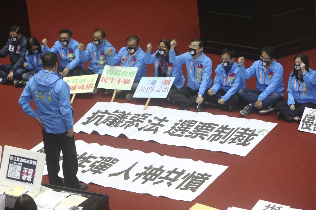 Opposition Kuomintang lawmakers protest against the bill in the legislative chamber in Taipei on Tuesday. Photo: AP