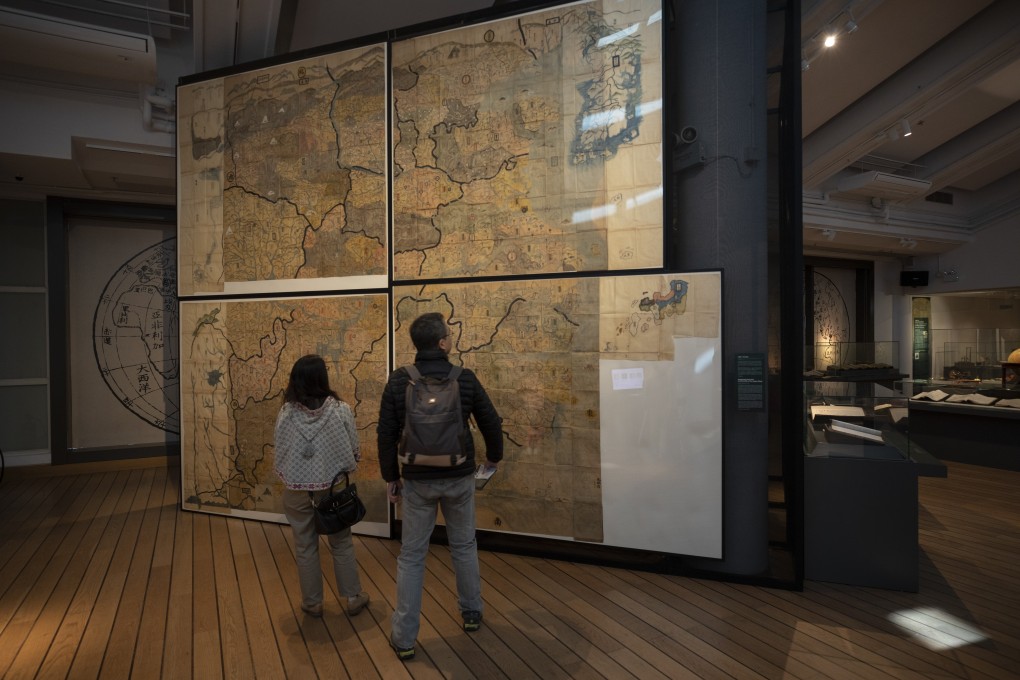 People looking at the Huang-Ming Yitong Da Tu (Unified Atlas of the August Ming) at the Hong Kong Maritime Museum, part of an exhibition called “The World on Paper: From Square to Sphericity”. Photo: Antony Dickson