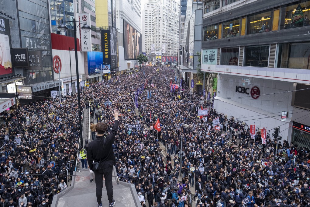 Demonstrators march through Hong Kong’s Causeway Bay on New Year’s Day before the protest descended into violence and vandalism. Photo: Bloomberg