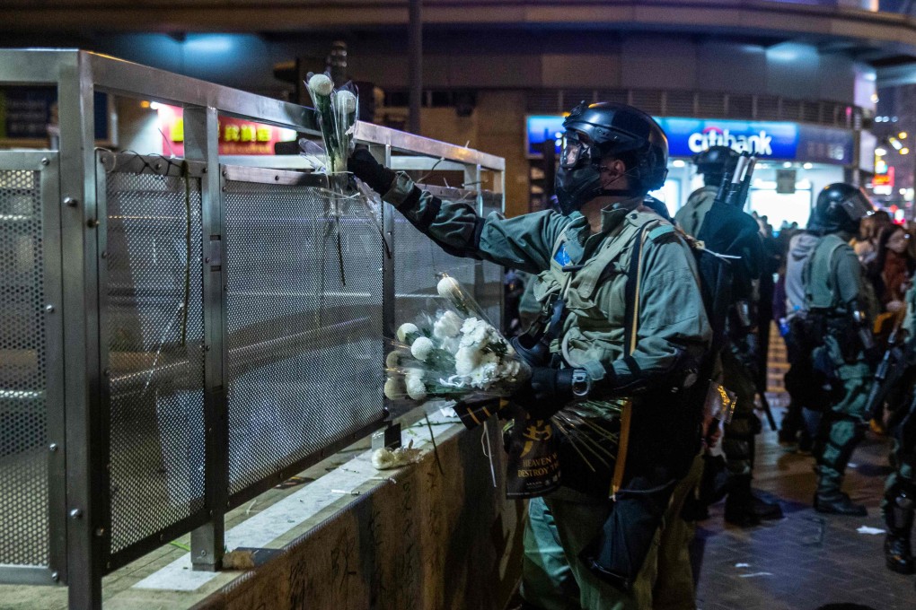Police remove flowers left at Prince Edward MTR station on Tuesday. Opinion polls have shown that roughly half of respondents believe people died during a police clearance operation at the station on August 31. Photo: AFP