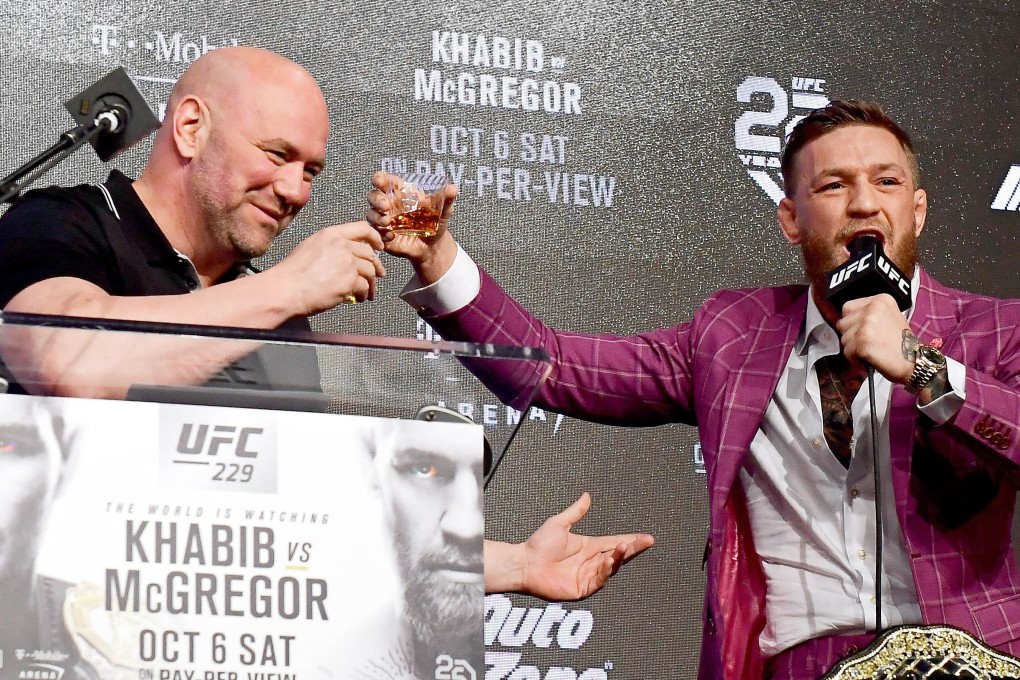 Conor McGregor shares his Irish whiskey with UFC president Dana White during the UFC 229 press conference in 2018 Photo: AFP
