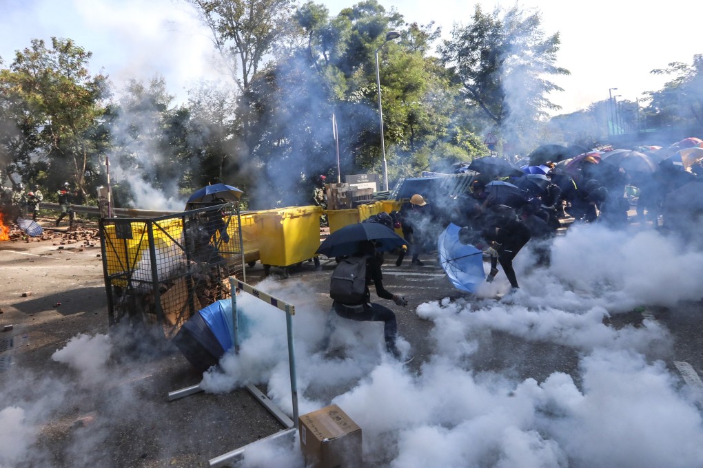 Riot police fire tear gas to disperse anti-government protesters from the road in front of Chinese University in Sha Tin on November 11. Photo: Felix Wong