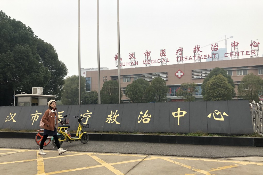 A pedestrian outside the hospital where those affected by the unidentified virus are being treated. Photo: Simon Song