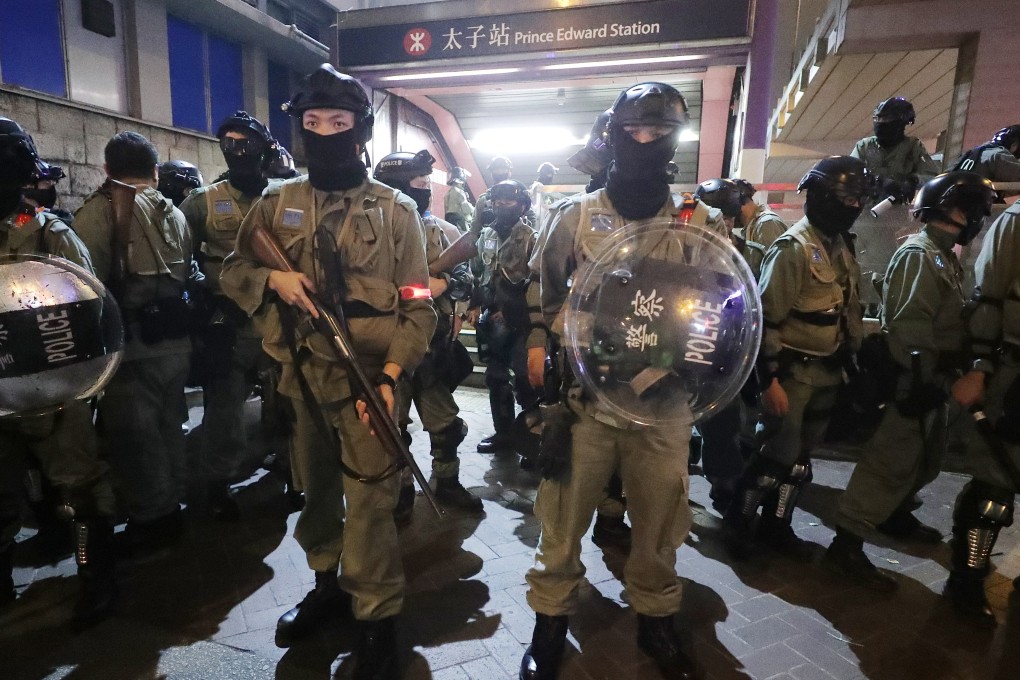 Anti-riot police outside of the Prince Edward MTR station as anti-government protesters gather around the station on December 31. Photo: Edmond So