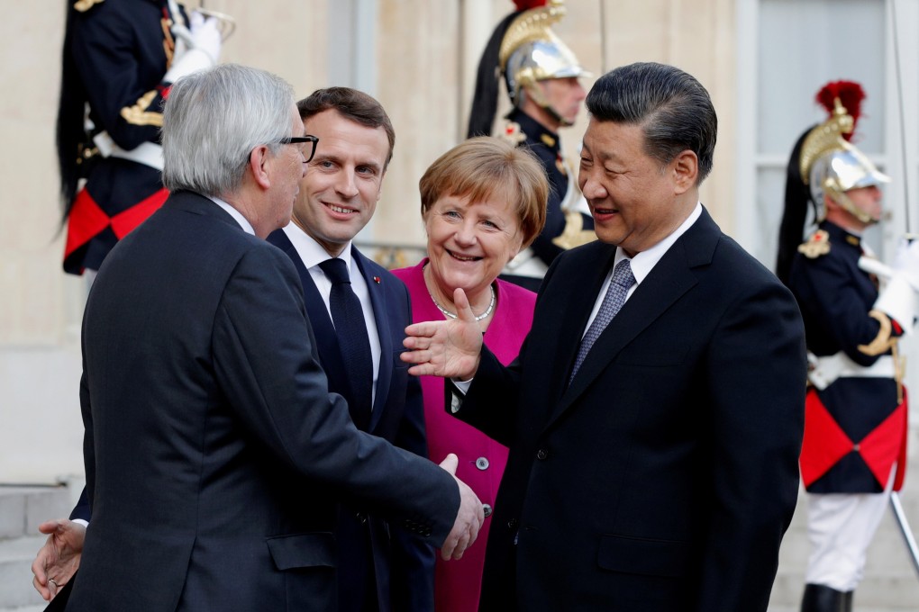 Chinese President Xi Jinping (right) reaches for the hand of former European Commission president Jean-Claude Juncker in greeting as French President Emmanuel Macron and German Chancellor Angela Merkel look on, at the Elysee Palace in Paris last March. Photo: Reuters