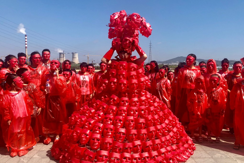 Kong Ning, a 62-year-old artist from Inner Mongolia, China, creates dresses that highlight pressing issues – such as this dress made of red masks she designed to raise awareness of global warming. The red masks represent people feeling hot and burned.