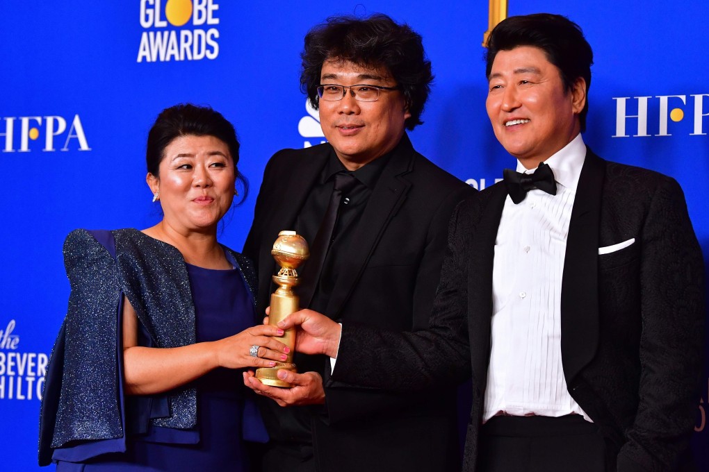 South Korean film director Bong Joon-ho (centre) poses with the best foreign language Golden Globe for Parasite. The win adds to the Oscar buzz surrounding the film. Photo: AFP