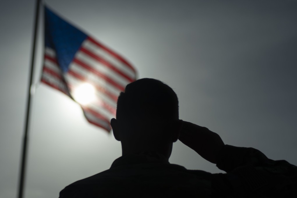A US Air Force Staff Sgt salutes the flag during a ceremony signifying the change from tactical to enduring operations at Camp Simba, Manda Bay, Kenya. Photo: US Air Force via AP