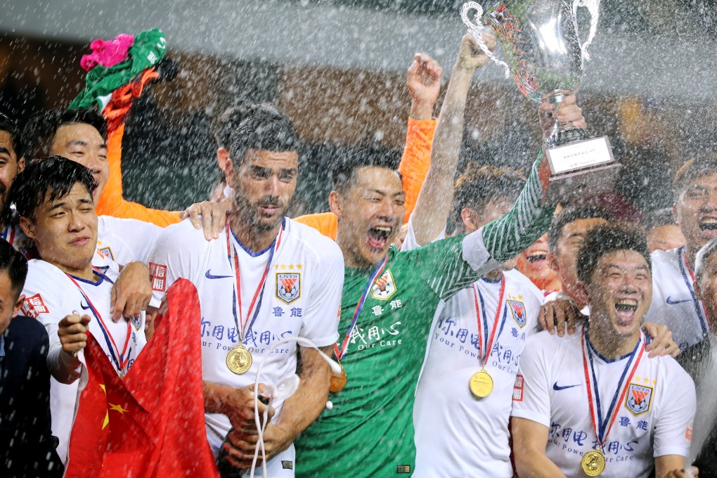 Shandong Luneng Taishan players celebrate winning last year’s Lunar New Year Cup at Hong Kong Stadium. Photo: Dickson Lee