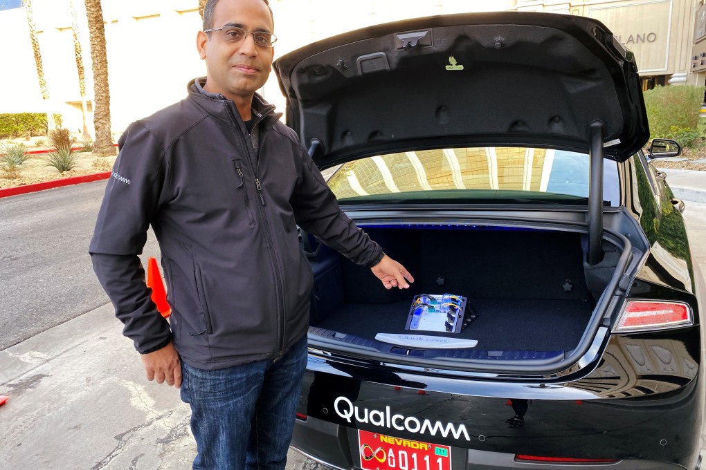 Dheeraj Ahuja, senior director of engineering at Qualcomm, points at the new Snapdragon Ride autonomous driving computing system in the trunk of a demo car at the 2020 CES in Las Vegas, US, January 5, 2020. Photo: Reuters