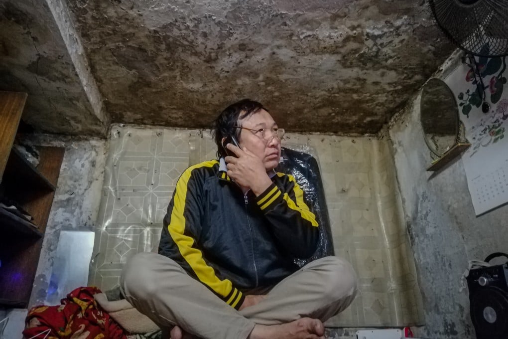 Hoang Van Xuan in the 5-square-metre mouldy attic that he calls his home. He works as a delivery man and motorbike taxi driver, but as the popularity of bike-sharing platforms explodes, he can barely make ends meet. Photo: Sen Nguyen