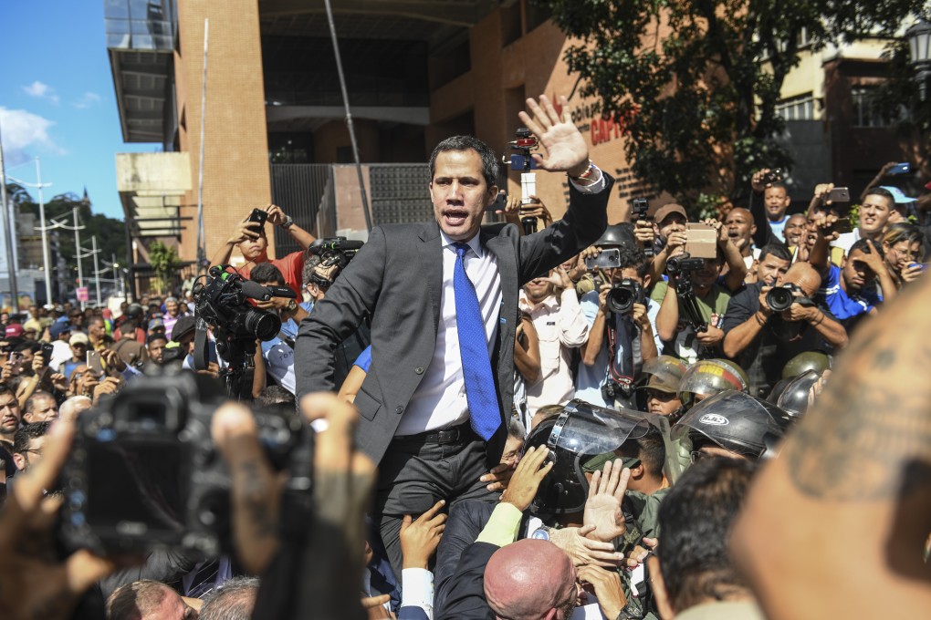 Juan Guaido gestures towards the crowd while attempting to enter the National Assembly building in Caracas, Venezuela, on Tuesday. Photo: Bloomberg