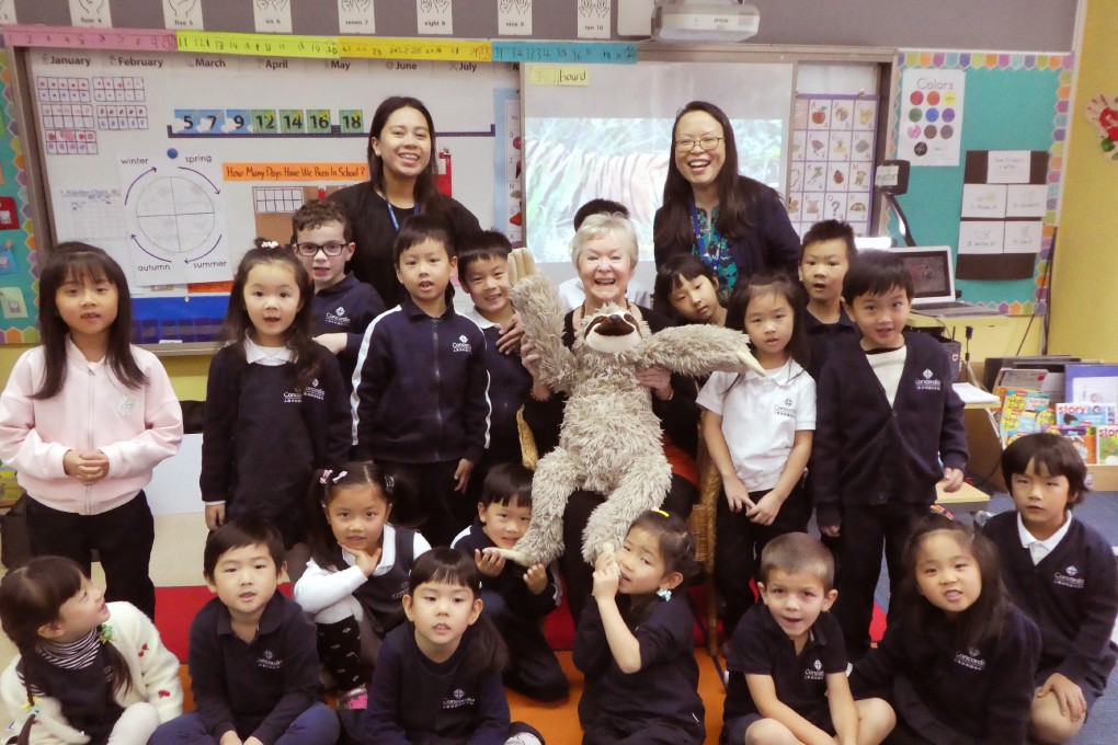 Author Jan Latta, Sleepy the Sloth and children at Concordia school in Shanghai, China. Photo: courtesy of Jan Latta
