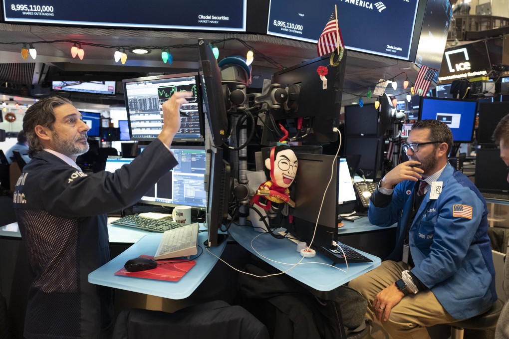 Stock traders at New York Stock Exchange watch stocks slip globally in quiet on the eve of 2020 with many markets closed. Photo: AP