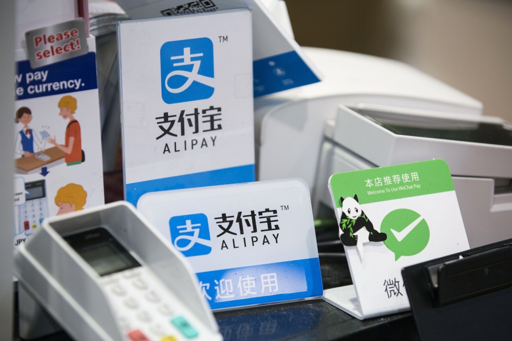 Signs for Ant Financial Services Group's Alipay, center top and center bottom, and Tencent's WeChat Pay, right at a store in Tokyo, Japan. File photo: Bloomberg