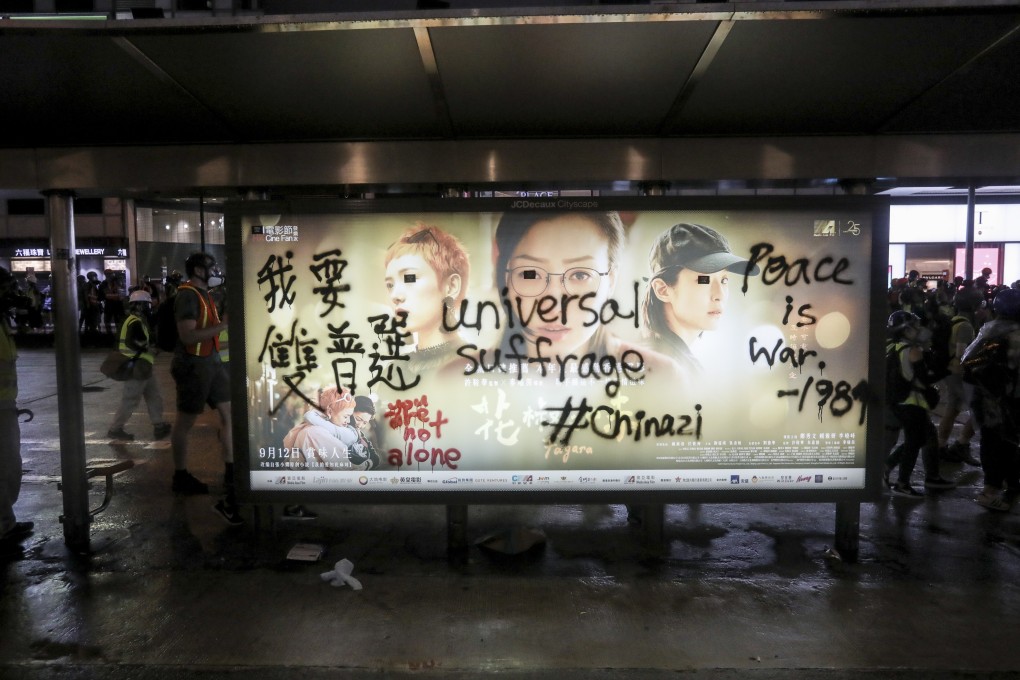 Anti-government slogans are seen on an advertising board at a bus stop in Hong Kong. Photo: EPA-EFE