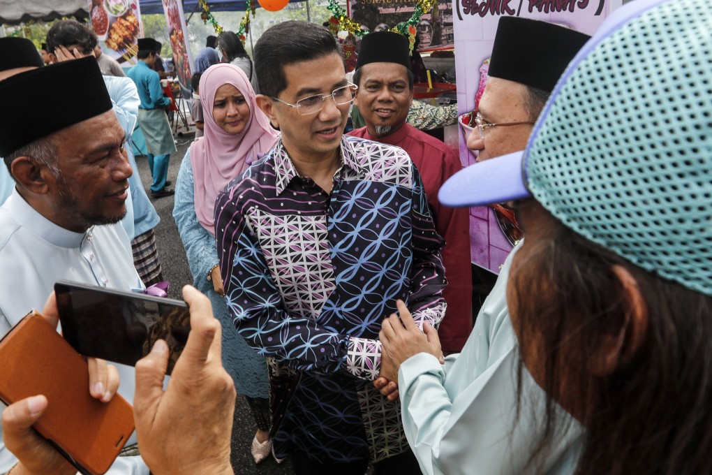Malaysian Economic Affairs Minister Azmin Ali (C). Photo: EPA-EFE