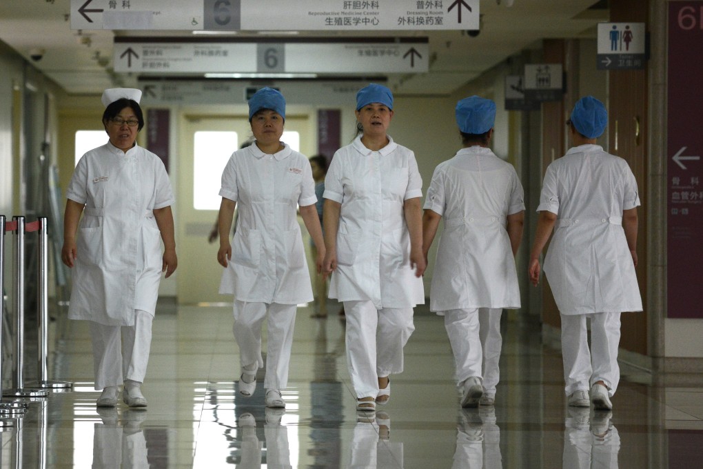 A group of nurses walk along a corridor at a hospital in Beijing. Photo: AFP
