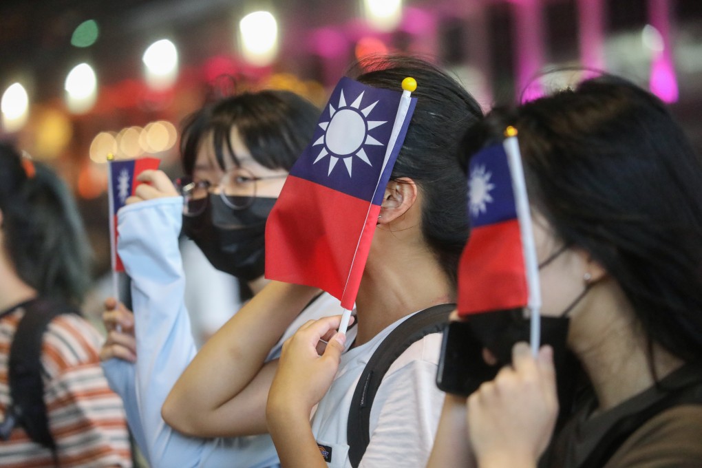 Protesters wave the Taiwanese flag outside the Tsim Sha Tsui Police Station in celebration of the Double Tenth Festival, national day for the Republic of China. Photo: Dickson Lee