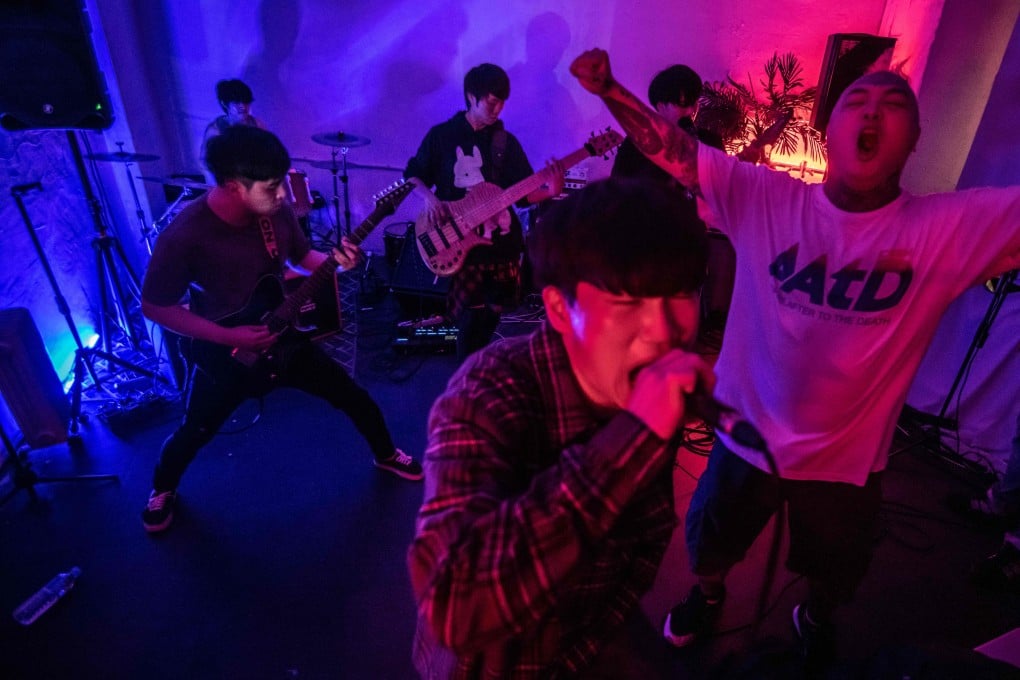 Singer Chu Yeonsik (centre) and guitarist Kim Sangwan (left) of post hard core metal band Monsters Dive during their set at a venue in Seoul. Photo: Ed Jones/AFP
