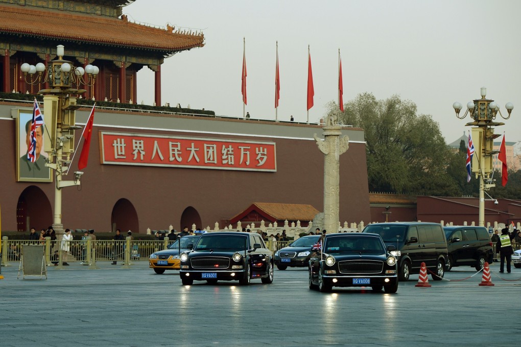 British Prime Minister David Cameron is driven past the portrait of late Chinese leader Mao Zedong in a Chinese-made Red Flag limousine at Tiananmen Square in Beijing, on December 2, 2013. Photo: AFP