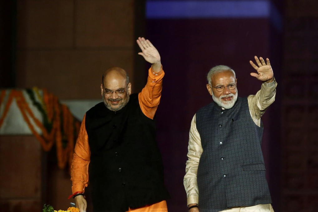 Indian Prime Minister Narendra Modi (right) and Bharatiya Janata Party president Amit Shah, now minister of home affairs, wave to supporters at the party headquarters in New Delhi on May 23, 2019, after victory in the national elections which returned Modi to power. Photo: Reuters