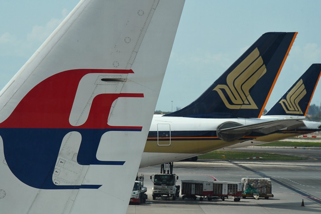 Malaysia Airlines and Singapore Airlines planes at Changi Airport in Singapore. Photo: Reuters