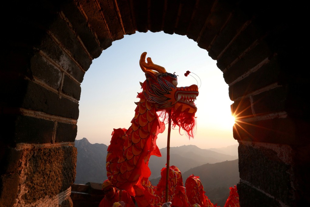 Performers take part in a dragon dance at sunrise on the Mutianyu section of the Great Wall of China in the Huairou district of Beijing on January 1. Photo: Reuters