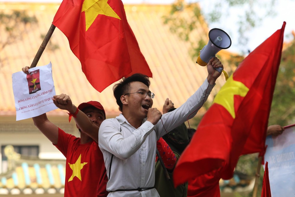 Anti-China protesters wave Vietnamese flags and shout slogans in front of the Chinese embassy in Hanoi. Photo: AFP