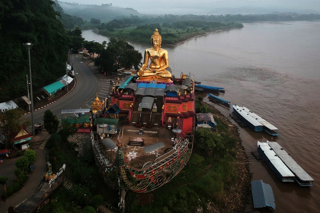 A giant Buddha on the Thai side of the Golden Triangle in Chiang Rai province, with Myanmar in the background. Photo: AFP