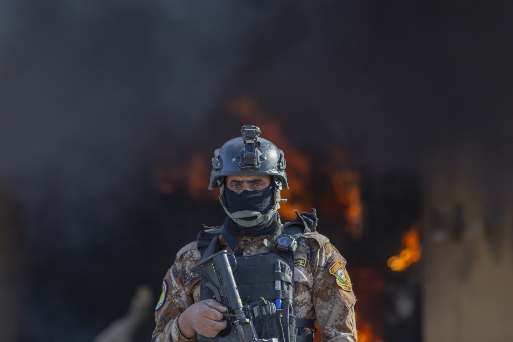 An Iraqi soldier stands guard in front of the US embassy in Baghdad after pro-Iranian militiamen set a fire on January 1. Photo: AP