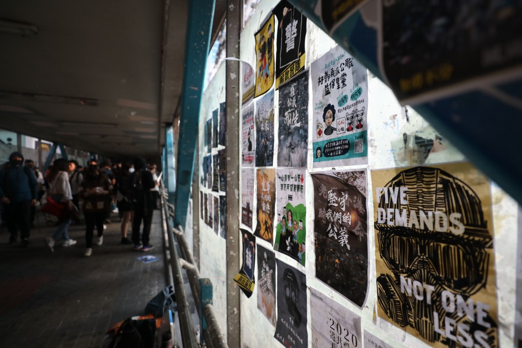 Protesters put up posters on a footbridge in Causeway Bay. Photo: Xiaomei Chen