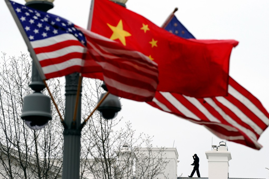 A Secret Service agent guards his post on the roof of the White House as a lamp post is adorned with Chinese and US national flags. The Pentagon’s move to counter China in the Indo-Pacific is certain to vex Beijing. Photo: AFP