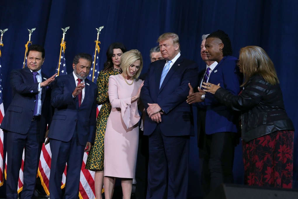 A group of religious leaders pray for President Donald Trump at a campaign rally at El Rey Jesus, an evangelical megachurch in Miami, on January 3. Photo: TNS