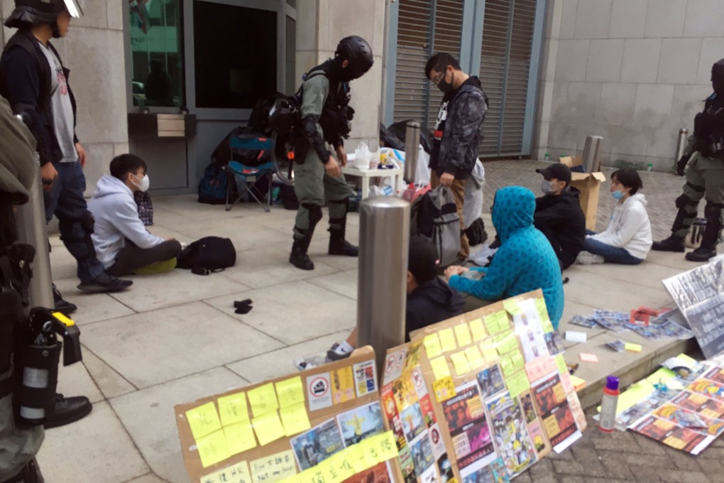 Police stop and search protesters outside the British consulate on Saturday. Photo: Kanis Leung