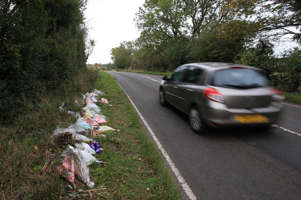 Floral tributes are placed by the side of the road near RAF Croughton in Northamptonshire, England, at the spot where Harry Dunn was killed in an accident. Photo: AFP