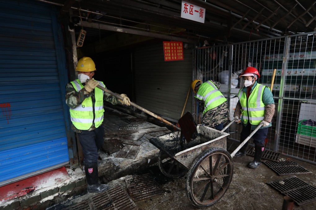 Workers clean a seafood market in Wuhan linked to an outbreak of a coronavirus. Photo: Simon Song