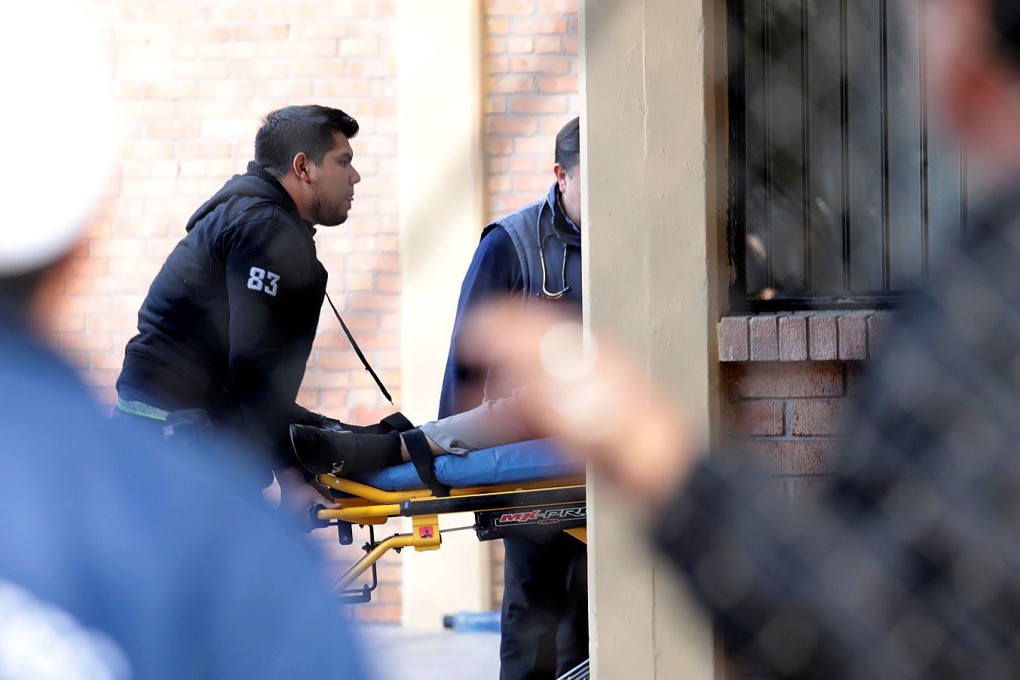 Paramedics carry a person on a stretcher after a shooting at a private school in Torreon, Mexico, on Friday. Photo: Reuters