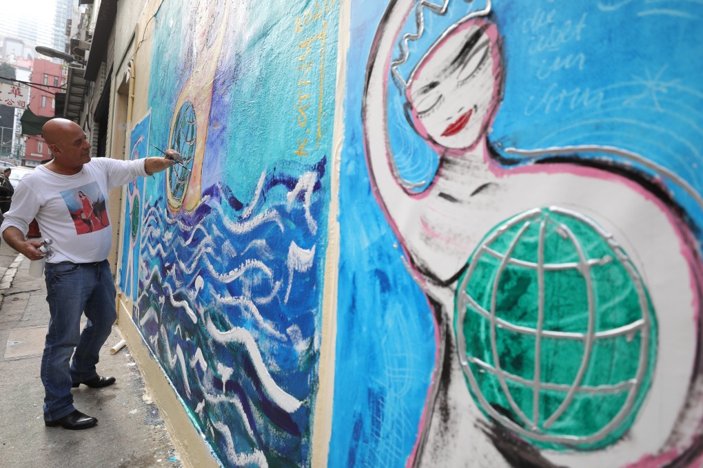 Kiddy Citny puts the finishing touches to his latest mural in Sheung Wan. Photo: Dickson Lee