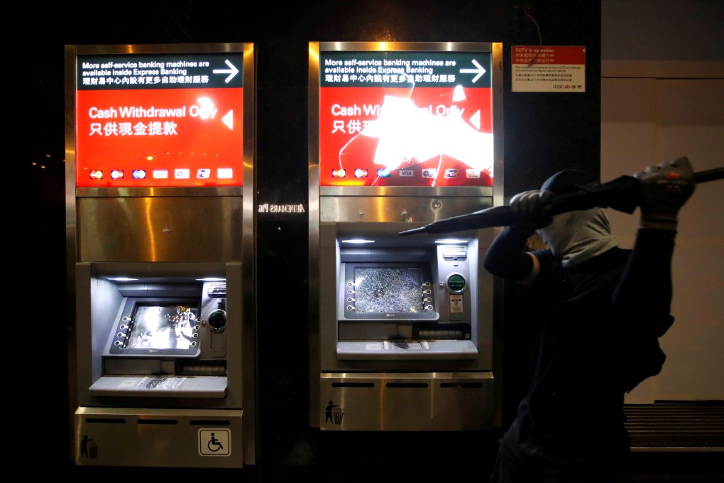An HSBC ATM machine is vandalised during a protest march on New Year’s Day. Photo: Reuters