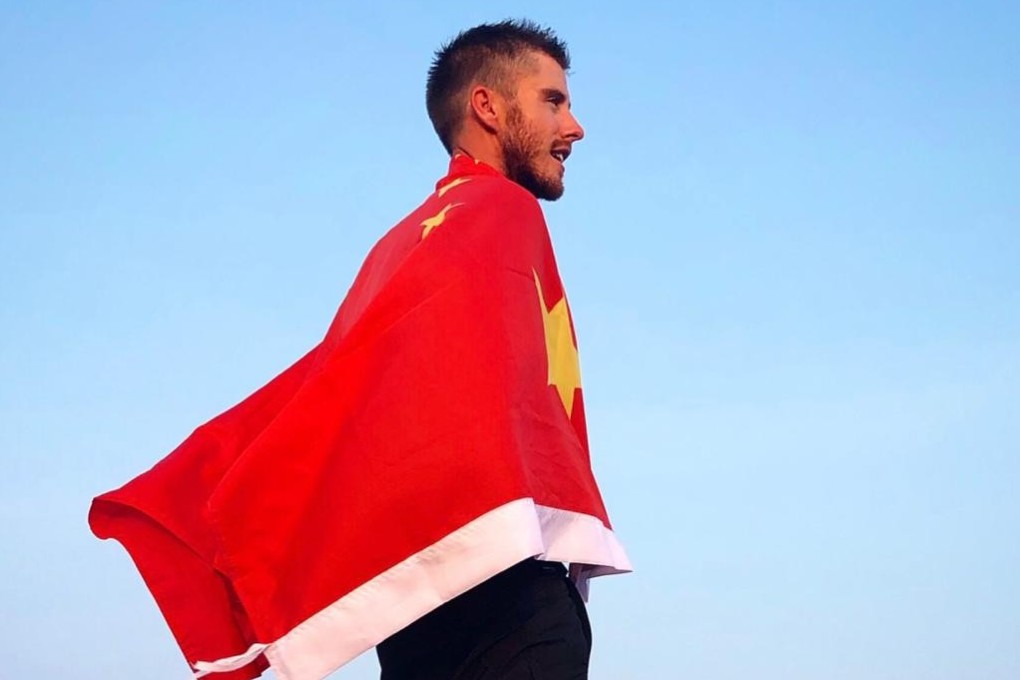 Ash Dykes wrapped in the Chinese flag while walking along the Yangtze River in China. Photo: Handout